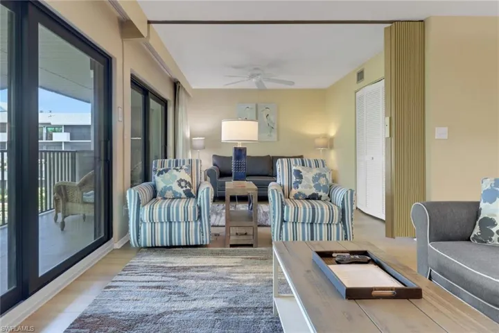Living room with ceiling fan and light wood-style flooring