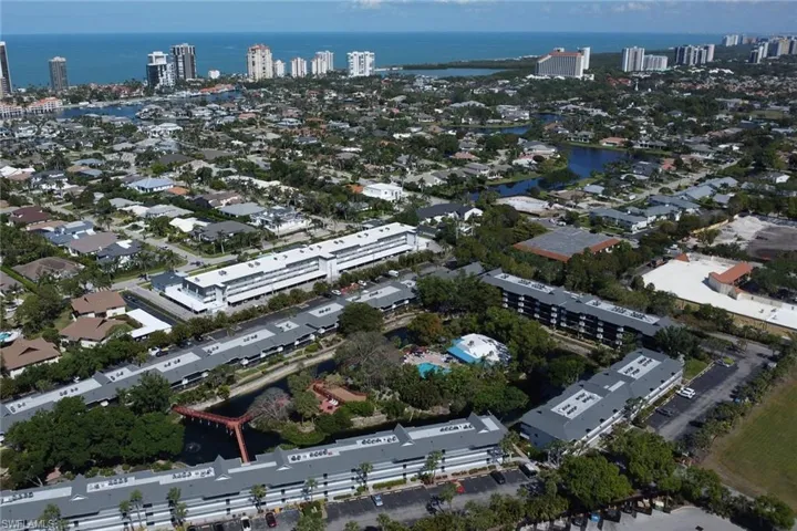 Aerial overview of property's location featuring a large body of water and nearby urban area