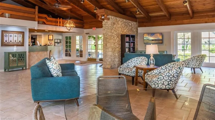 Living area featuring wooden ceiling, beam ceiling, a chandelier, french doors, and high vaulted ceiling