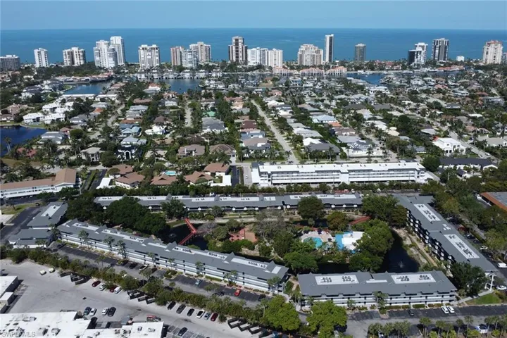 Aerial view of property's location featuring a large body of water and nearby urban area