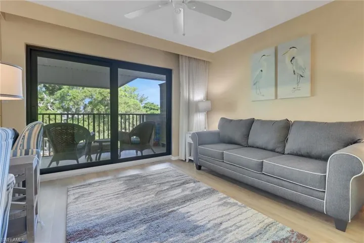 Living area with ceiling fan and wood finished floors