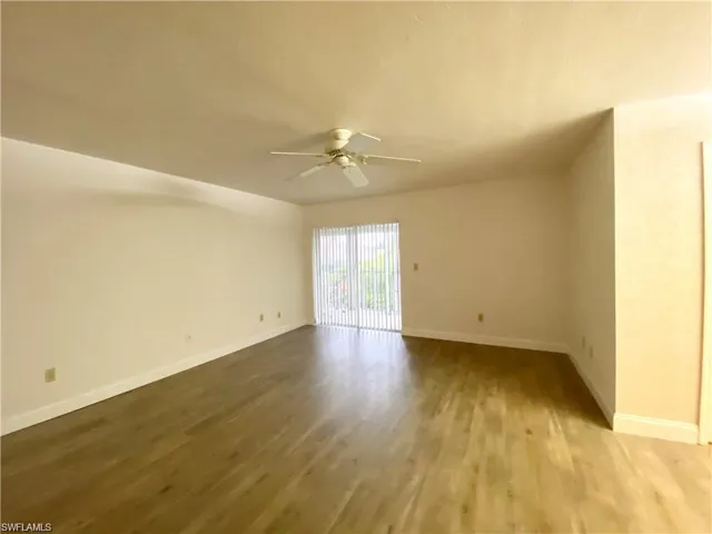 Unfurnished room with ceiling fan and wood finished floors