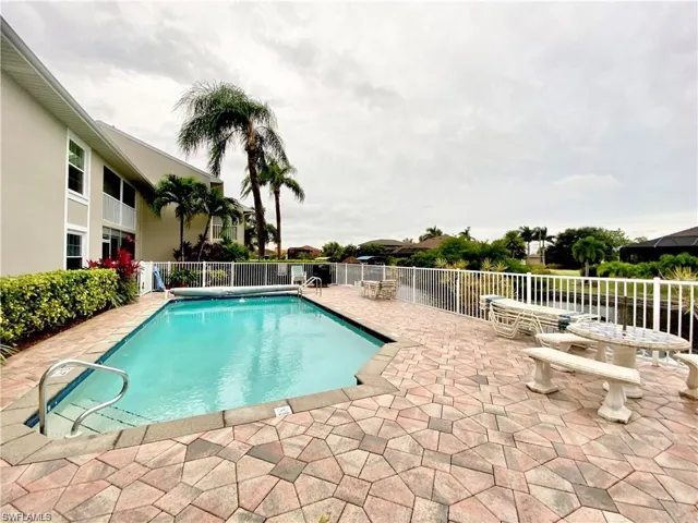 Community pool with a patio
