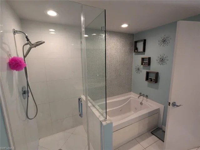 Bathroom featuring tile patterned floors and separate shower and tub