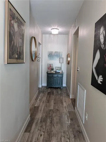 Hall featuring dark wood-type flooring