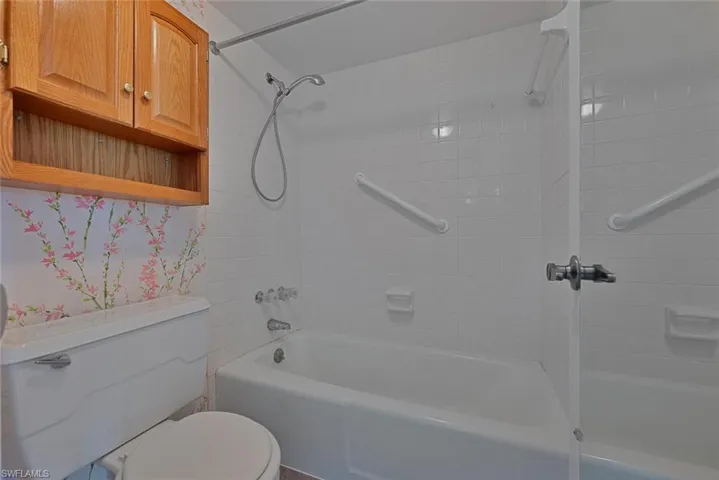 Bathroom featuring toilet and tiled shower / bath