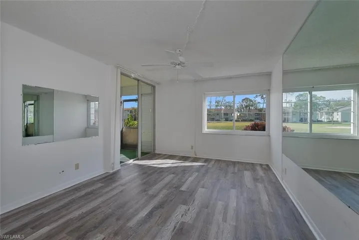 Spare room with a textured ceiling, ceiling fan, and hardwood / wood-style flooring