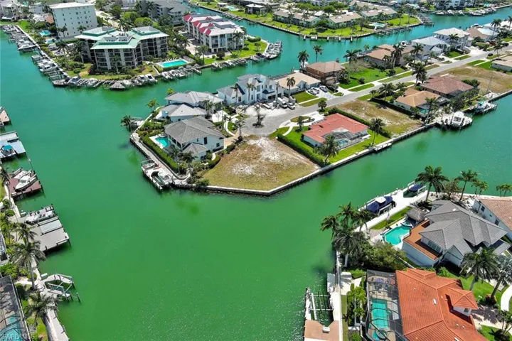 Birds eye view of property featuring a water view and a residential view