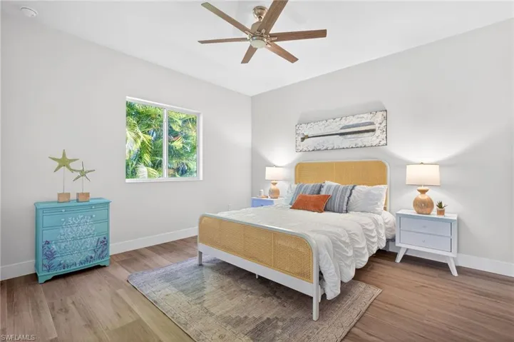 Bedroom with a ceiling fan and wood finished floors