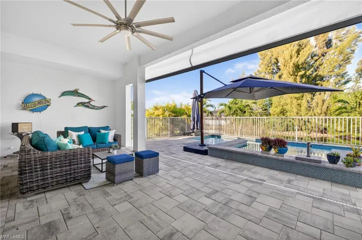 Fenced backyard featuring a ceiling fan, an outdoor lounge area, and a patio