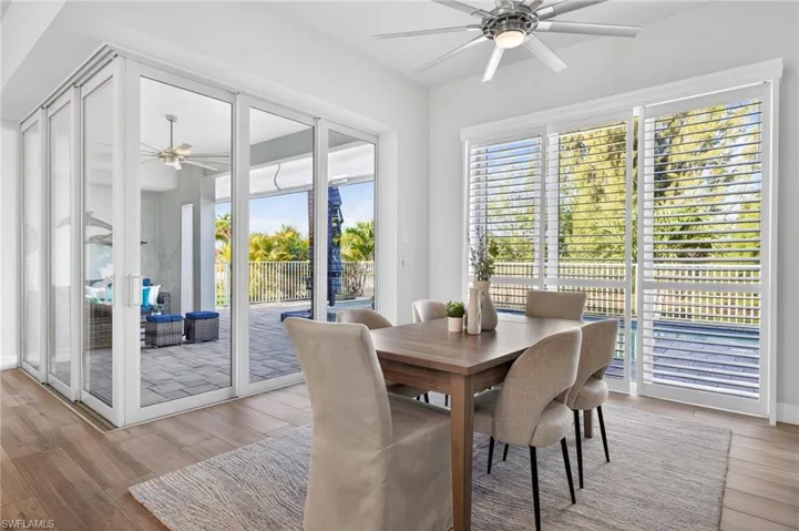 Dining area featuring ceiling fan, light wood-type flooring, and plenty of natural light