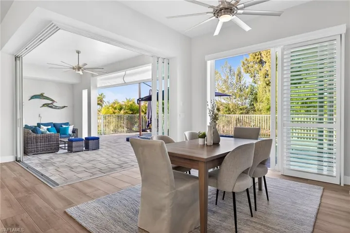 Dining room with ceiling fan and light wood-style floors