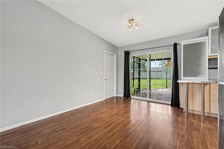 Wood-finish flooring, light gray wall paint, and a modern ceiling fixture