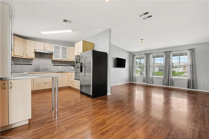 Expansive wood-finish flooring throughout the living space and kitchen