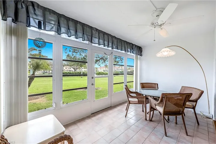 Sunroom featuring ceiling fan and french doors