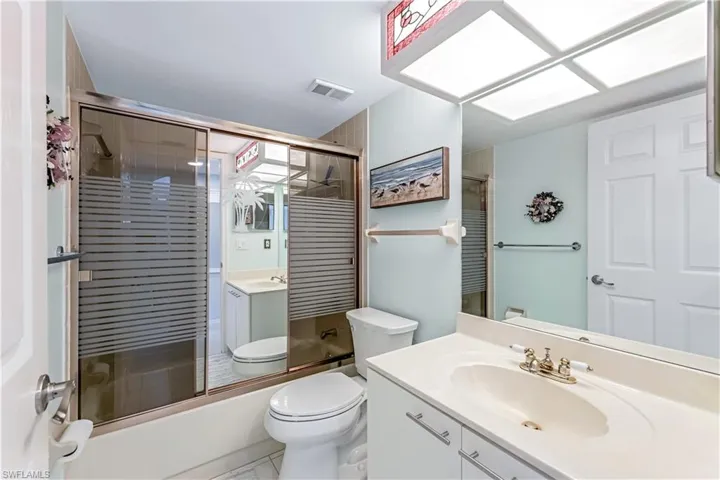 Full bath with vanity and enclosed tub / shower combo