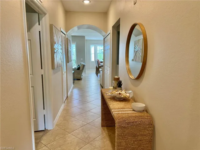 Hallway with light tile patterned flooring