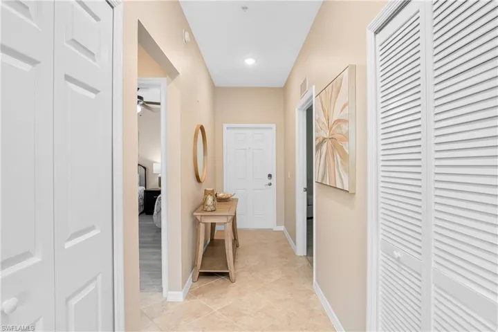 Hallway with light tile patterned floors