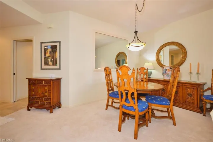 Carpeted dining area with baseboards