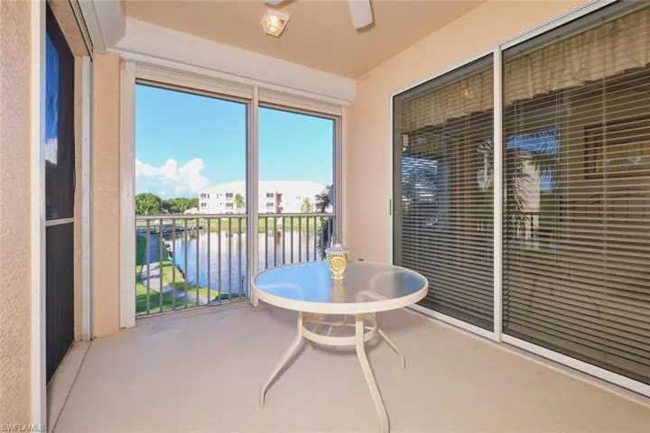 Sunroom featuring a water view