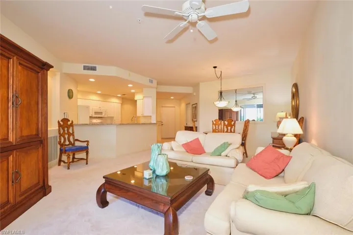 Living area with carpet, recessed lighting, and a ceiling fan