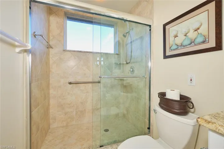 Full bath featuring a stall shower and vanity