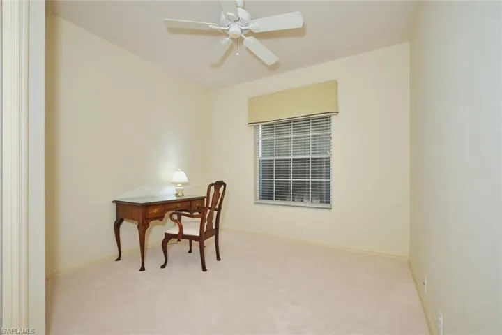 Office area with carpet floors and a ceiling fan