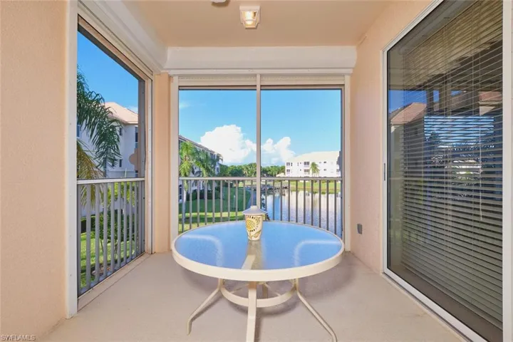Sunroom featuring a water view