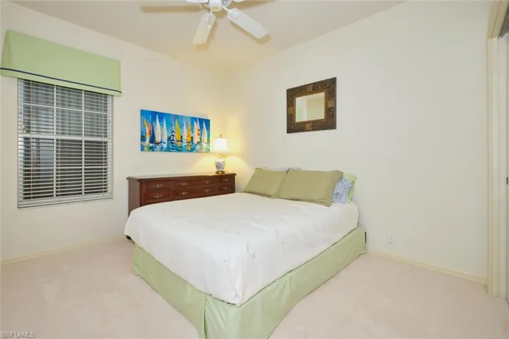 Bedroom featuring a ceiling fan and carpet floors
