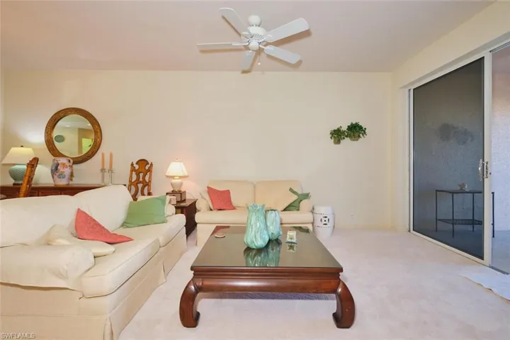 Living area featuring carpet floors and a ceiling fan