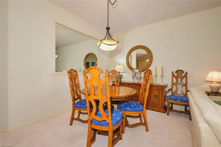 Carpeted dining area with baseboards