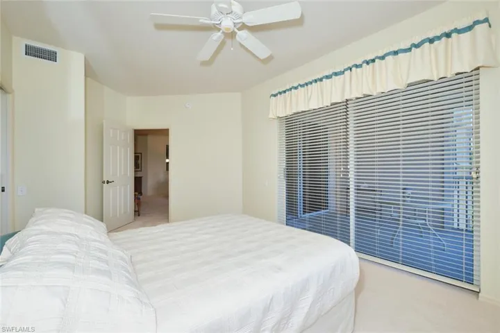 Bedroom featuring light carpet and ceiling fan