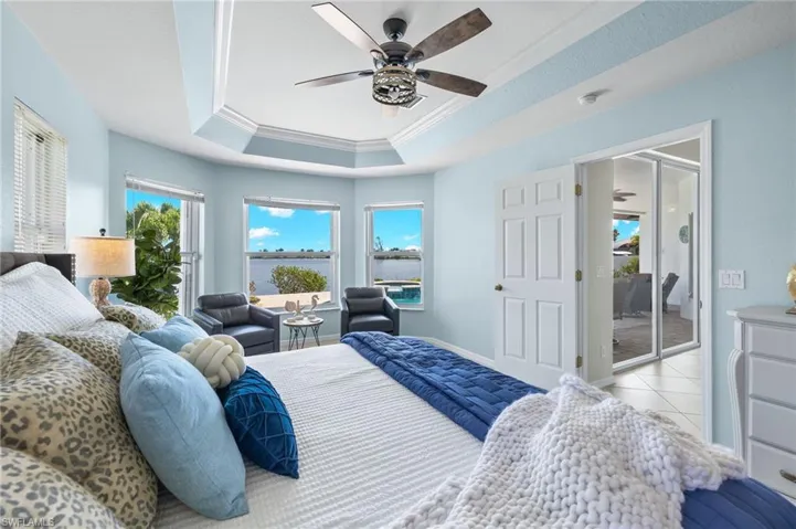 Primary bedroom is large with great views out to the gulf access lake and new light fixtures.