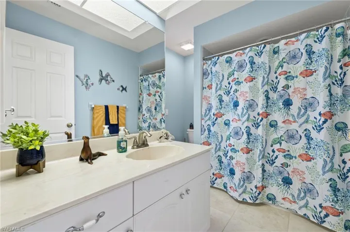 Guest bathroom doubles as a pool bath with a door leading out to the lanai.