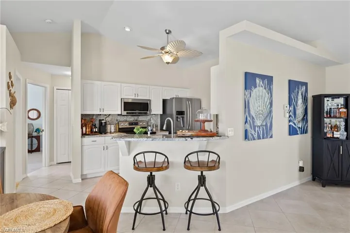 Kitchen is open to the living area with granite counter tops and views out to the lake