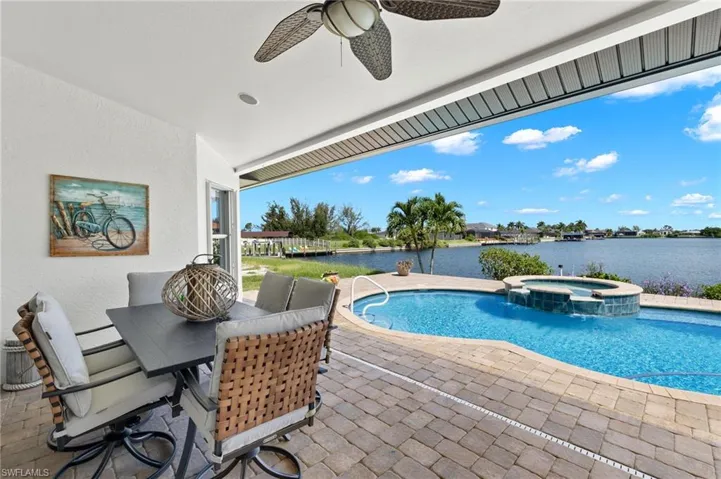 Large under truss lanai has space for dining and sitting by the pool and spa.