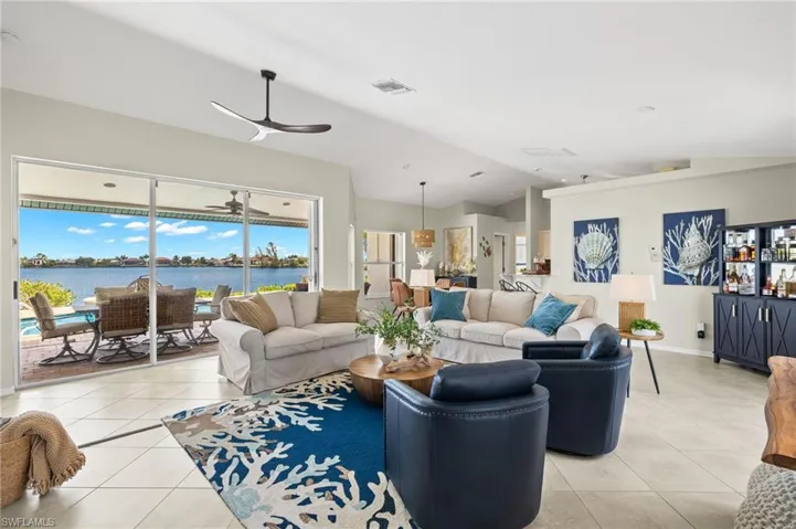 Great room is light and bright with amazing views out to the pool and gulf access lake.