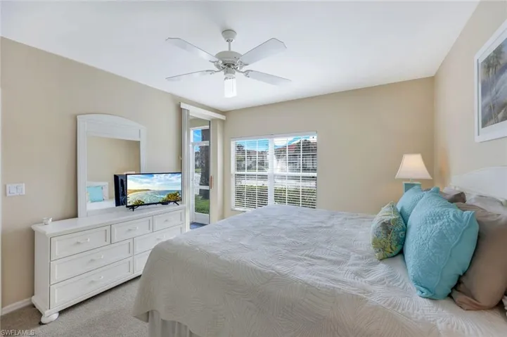 Bedroom featuring light colored carpet and ceiling fan