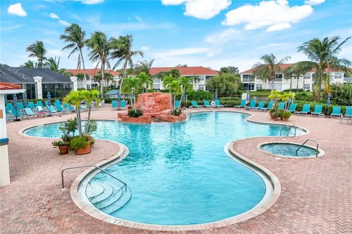 View of pool with a hot tub and a patio area