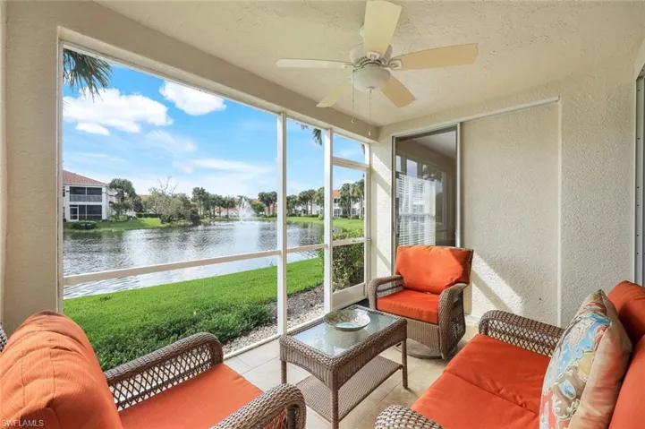 Sunroom featuring a water view and ceiling fan