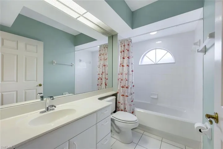 Full bathroom featuring toilet, vanity, tile patterned floors, and shower / tub combo with curtain