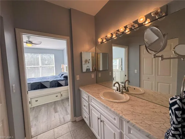 Bathroom with tile patterned floors and vanity