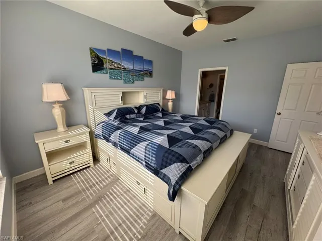 Bedroom featuring hardwood / wood-style floors and ceiling fan