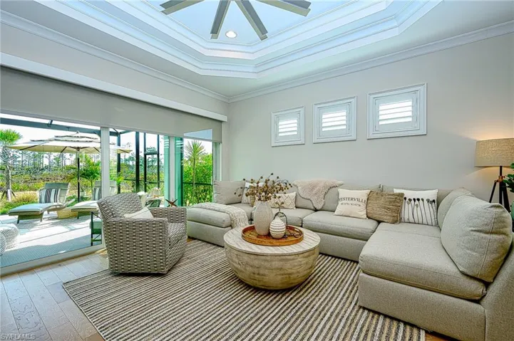 Living room featuring crown molding, hardwood / wood-style floors, and ceiling fan