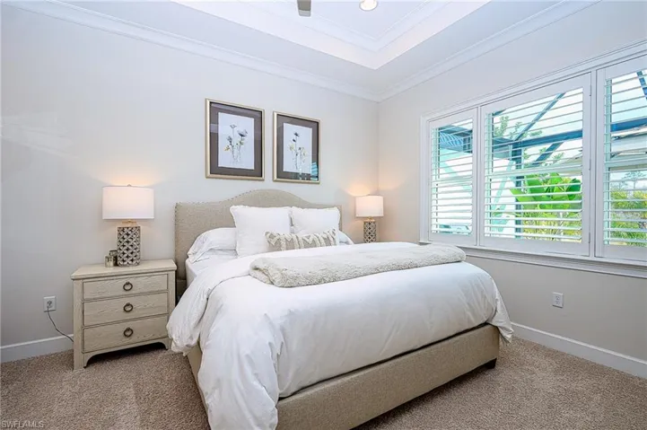 Primary Bedroom featuring crown molding and light colored carpet