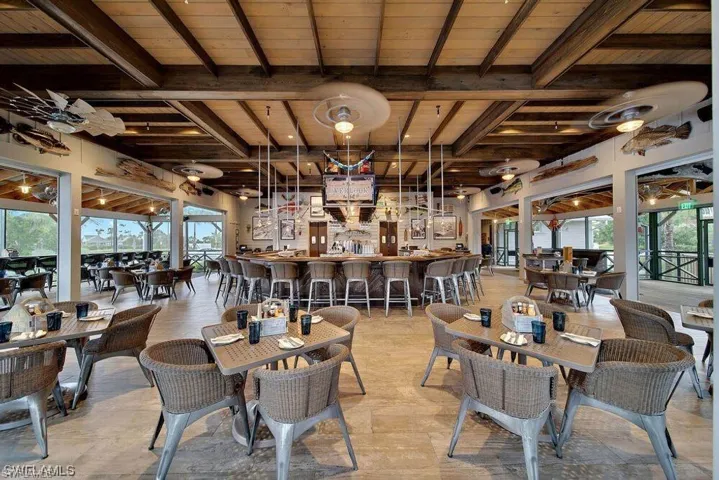 Overlook Bar & Grill featuring bar area, beam ceiling, and wood ceiling
