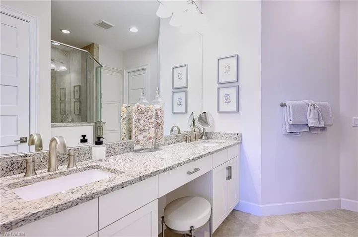 Master Bathroom with a shower with door, vanity, and tile patterned floors