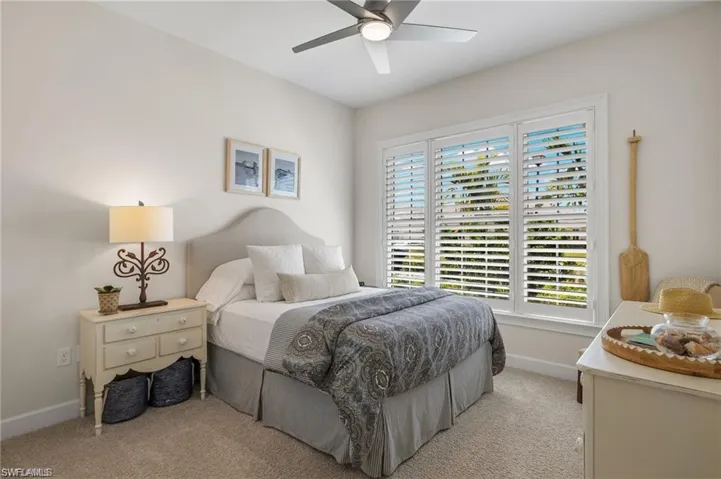 Guest Bedroom featuring ceiling fan and light colored carpet