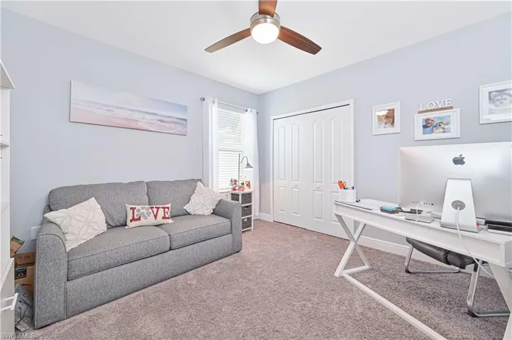 Office area featuring carpet and ceiling fan