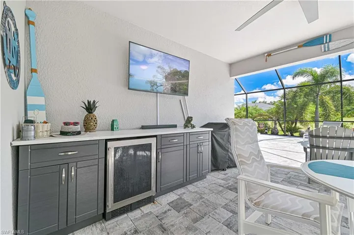 View of patio / terrace with area for grilling, a sunroom, a lanai, and ceiling fan
